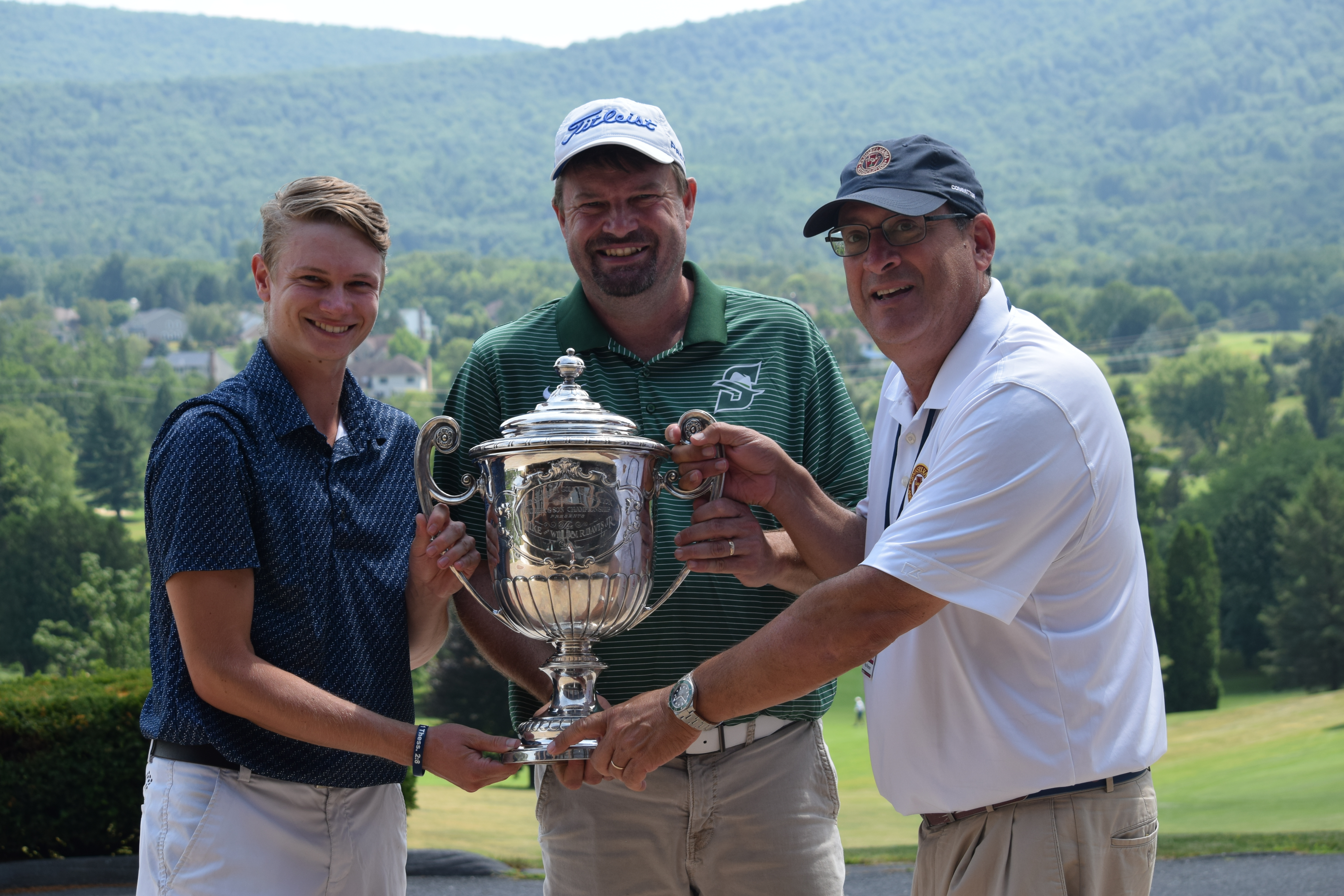 Caleb and Darrell Bryant (left, center) hold trophy with PAGA President Paul Romano.