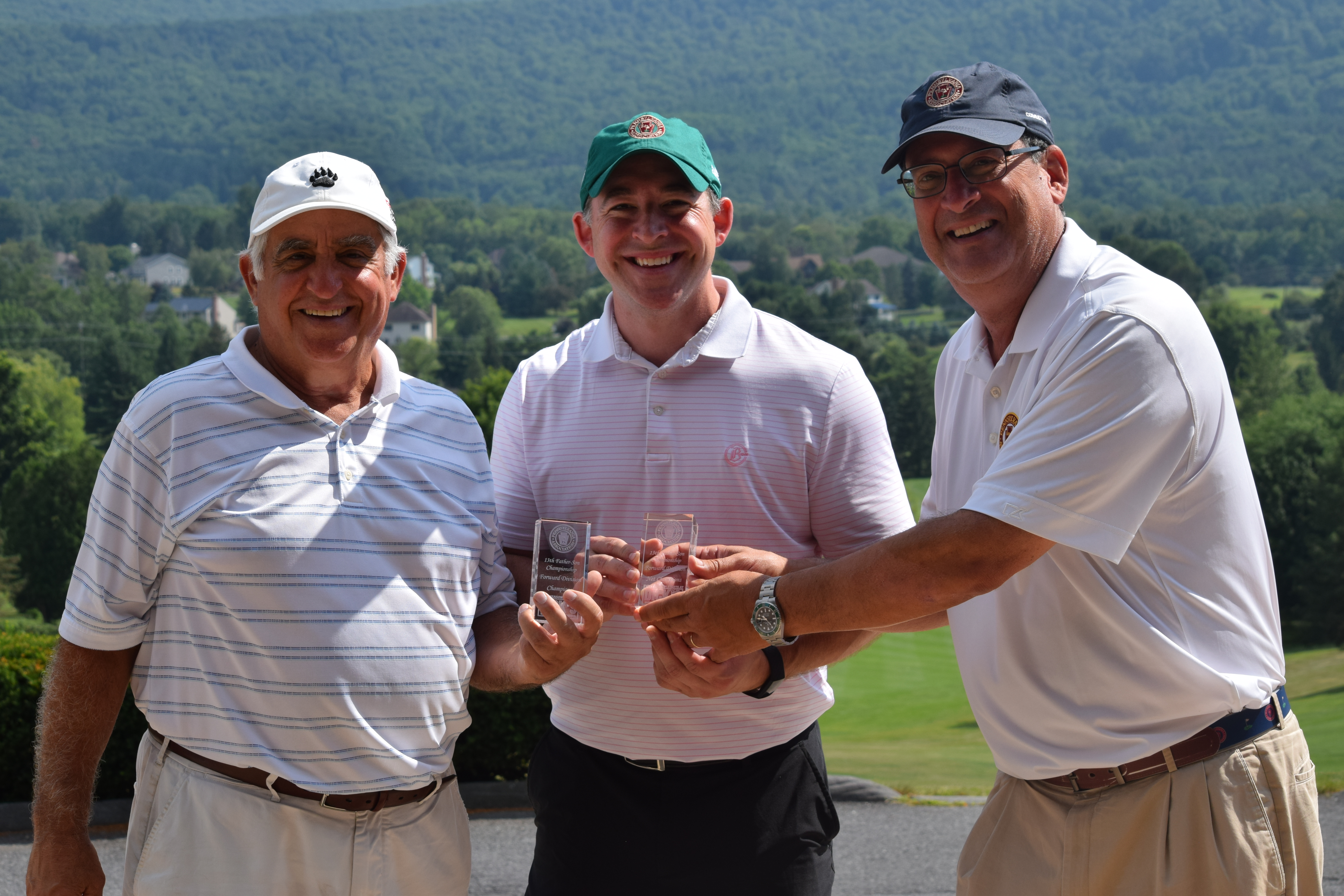 Vince Scarpetta Jr. (left) and Steve Scarpetta (right) hold the trophy with PAGA President Paul Romano (right).