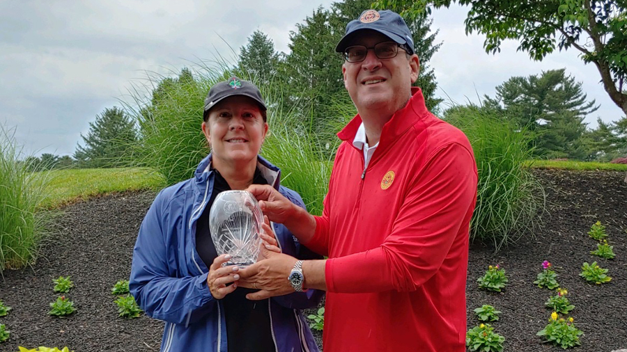 Karen  Siegel holding the trophy with PAGA President Paul Romano